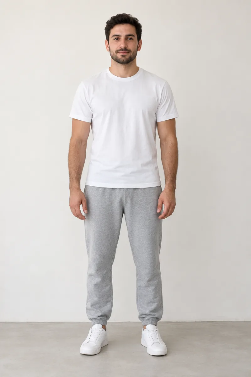 Man in a white t-shirt and grey sweatpants