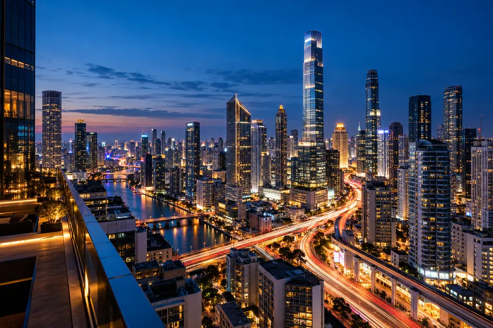 Night cityscape seen from a rooftop, glowing skyscrapers and light trails of traffic below, blue hour, long exposure, no readable signs