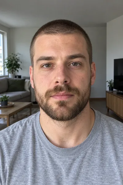 Eingabefoto: ein Mann mit kurzem braunem Bart und Buzz Cut in einem grauen T-Shirt