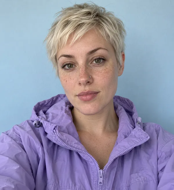 Input selfie: a woman with a platinum pixie cut in a lilac windbreaker