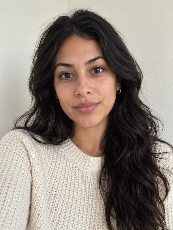 Input photo: a woman with long wavy black hair in a cream sweater